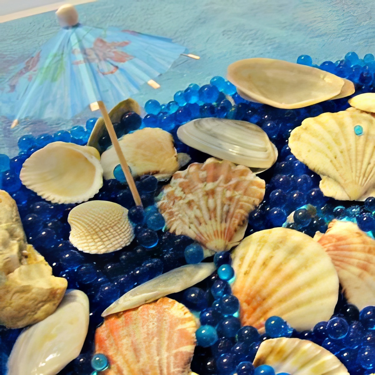 beach sensory bin with blue water beads as sensory bins for preschoolers