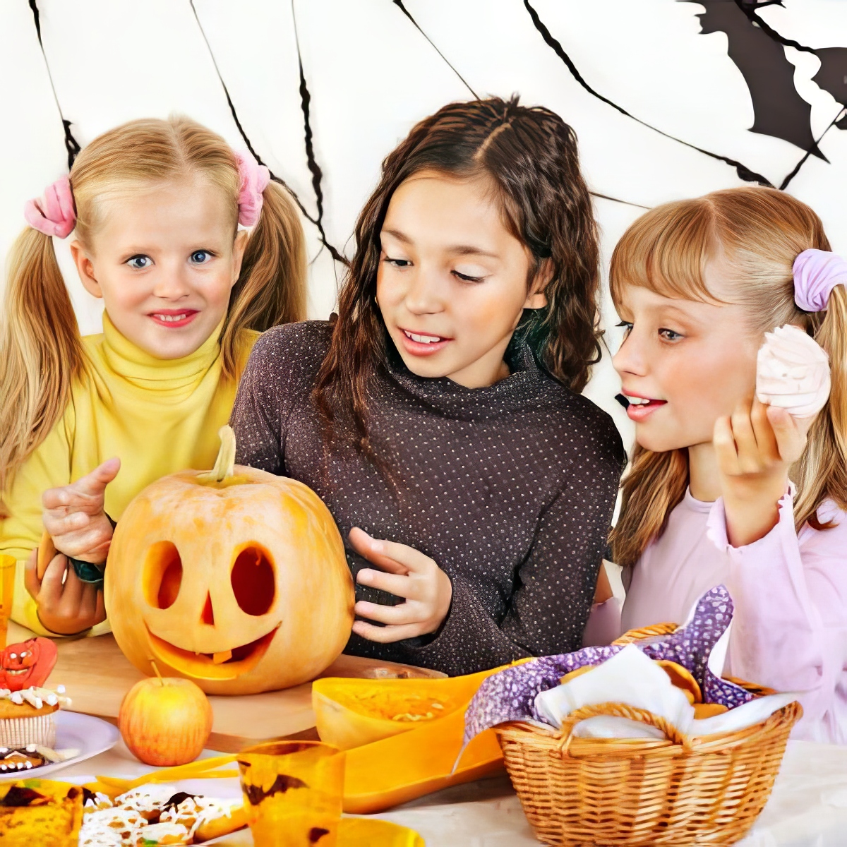 girls carving a pumpkin as halloween activities for 4 year olds