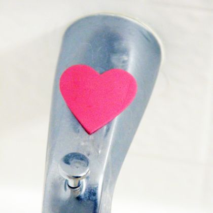 find the hearts game - heart shaped paper on a faucet for kids to hunt