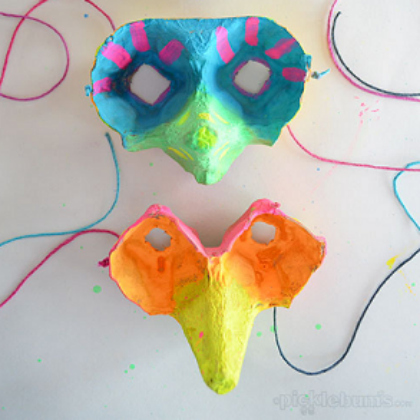 Two colorful egg carton masks with string