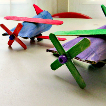 airplane made of cardboard rolls and popsicle sticks as as paper plane crafts for kids