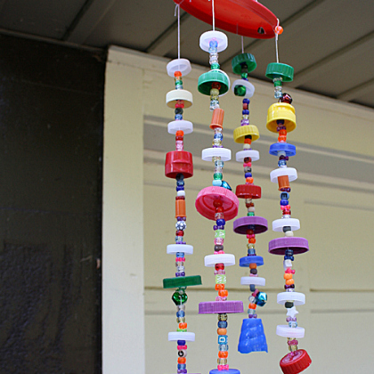 DIY Colorful Plastic Lid Wind Chime Crafts for Kids. Made of recyled plastic lids, strings and beads.