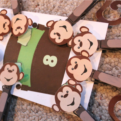 Clothes Pin Monkey Craft. 8 Silly Monkey Pins on a bed