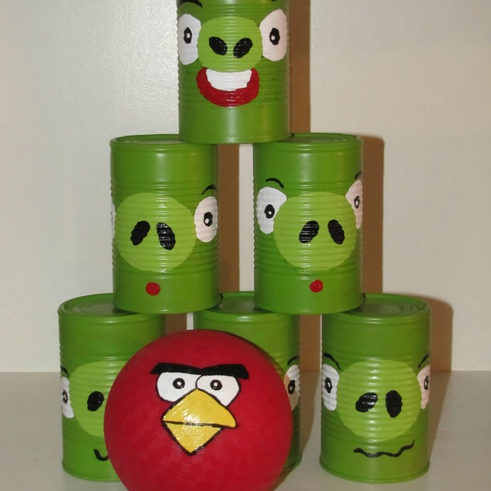 Six Green Angry Bird Toss Cans as Bowling Pins with Red Angry Bird Ball for Silly Slumber Party