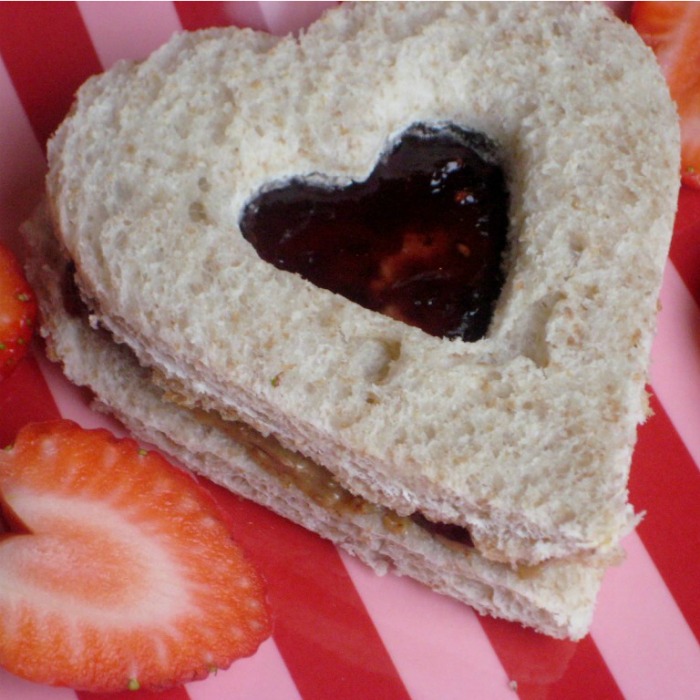Heart-shaped peanut butter and jelly finger sandwiches