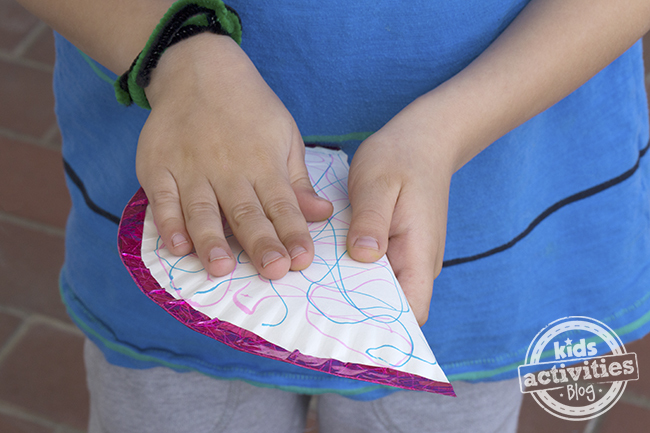 tambourine craft for kids - finished shown in child's hands